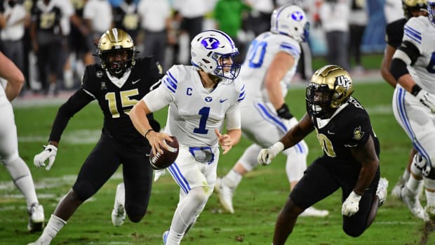 Zach Wilson scrambles against UCF